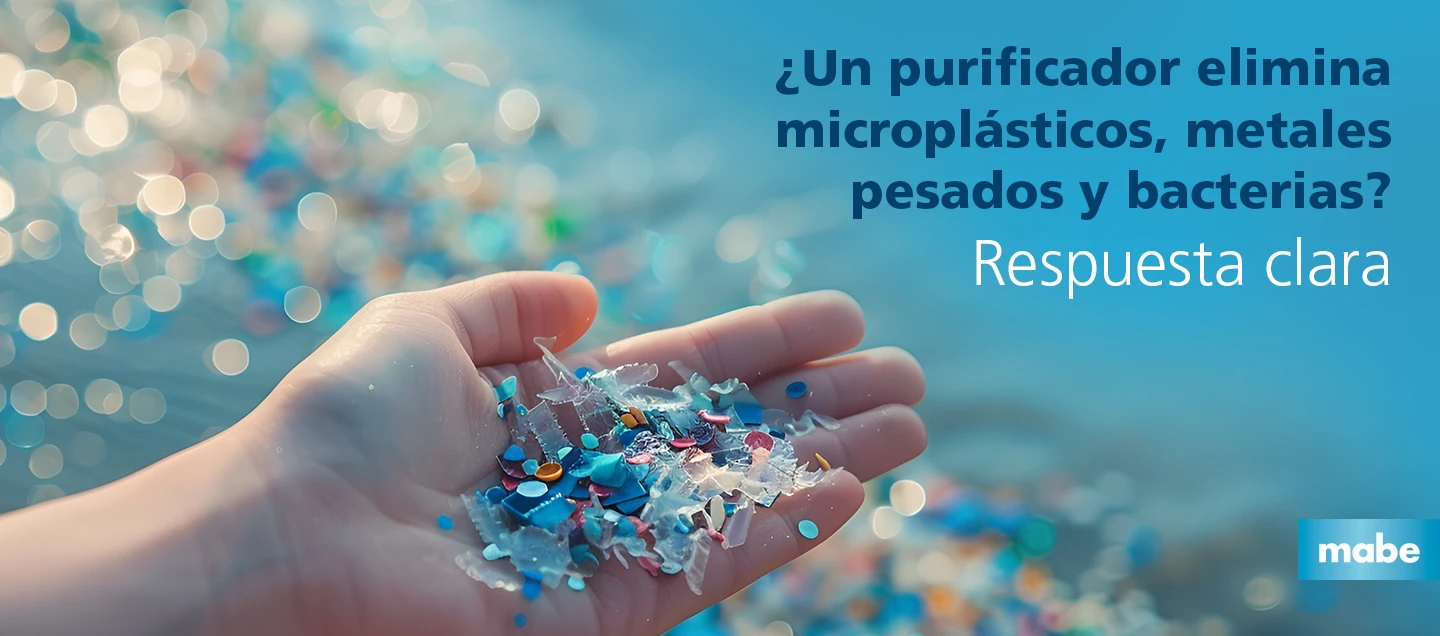 Mano sosteniendo microplásticos de distintos colores frente a un fondo azul desenfocado, con el texto “¿Un purificador elimina microplásticos, metales pesados y bacterias? Respuesta clara”, y logotipo de Mabe